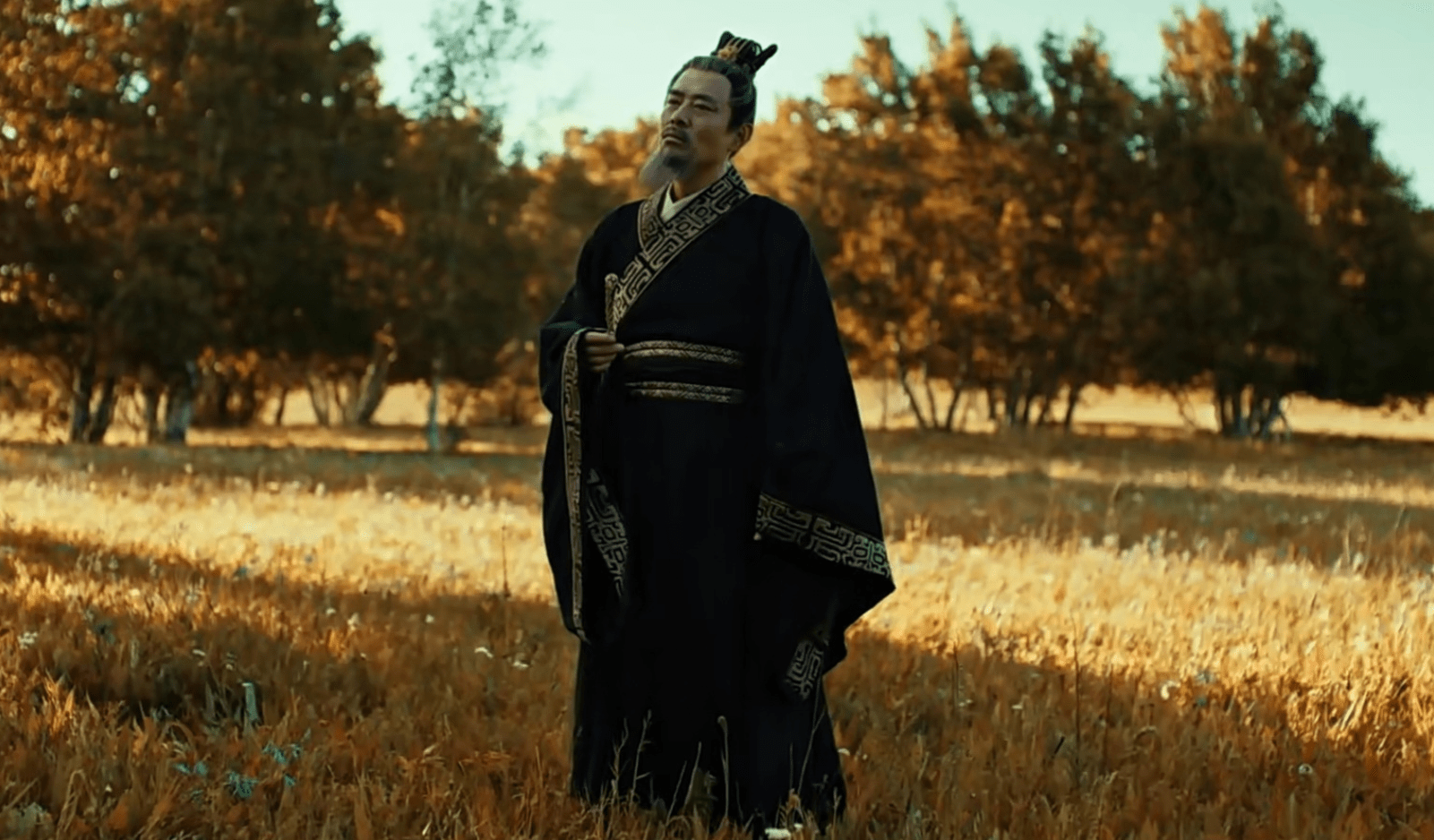An aged depiction of Yang Jian, Emperor Wen of the Sui dynasty, standing in a field.