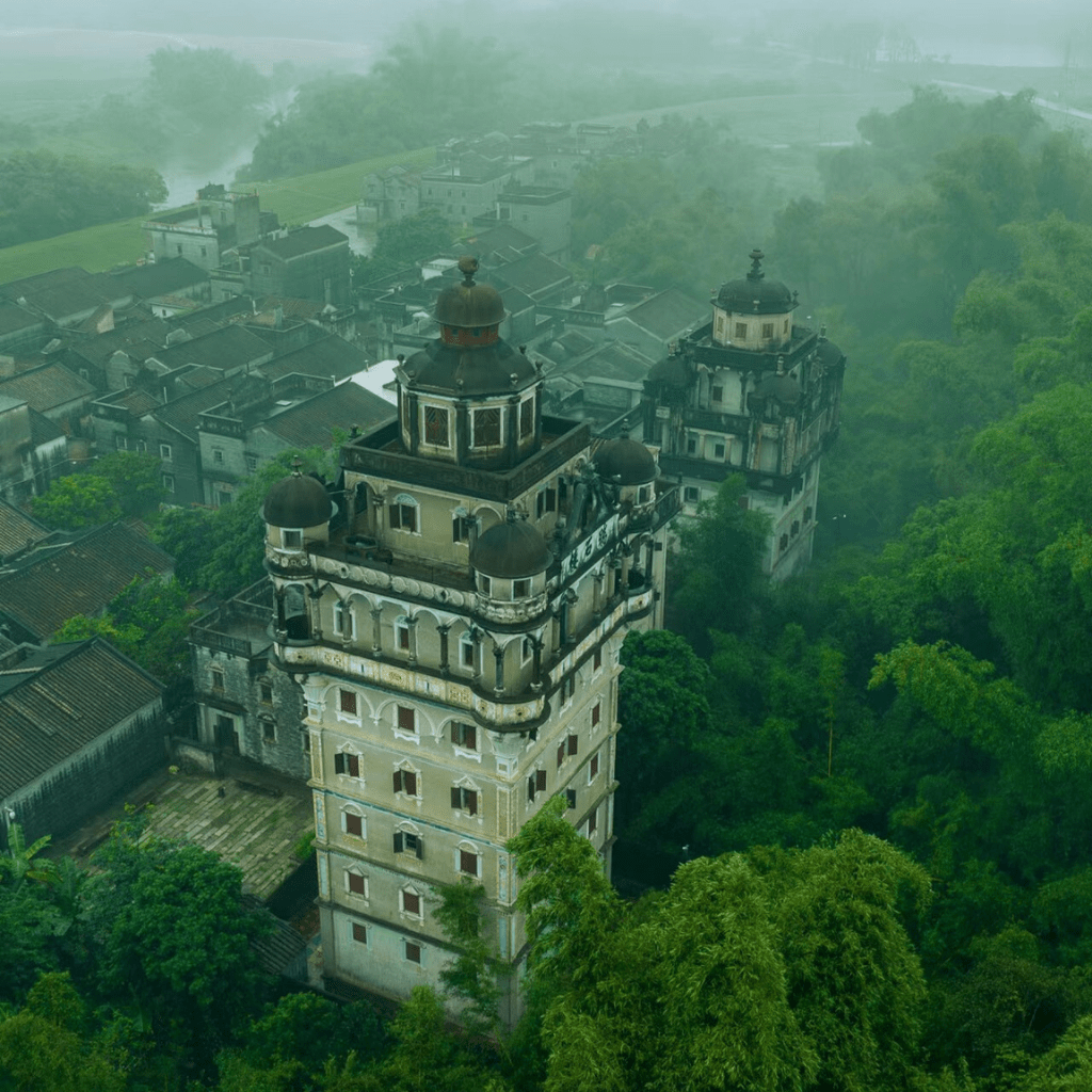 Ruishi Lou Diaolou tower surrounded by lush greenery in Kaiping