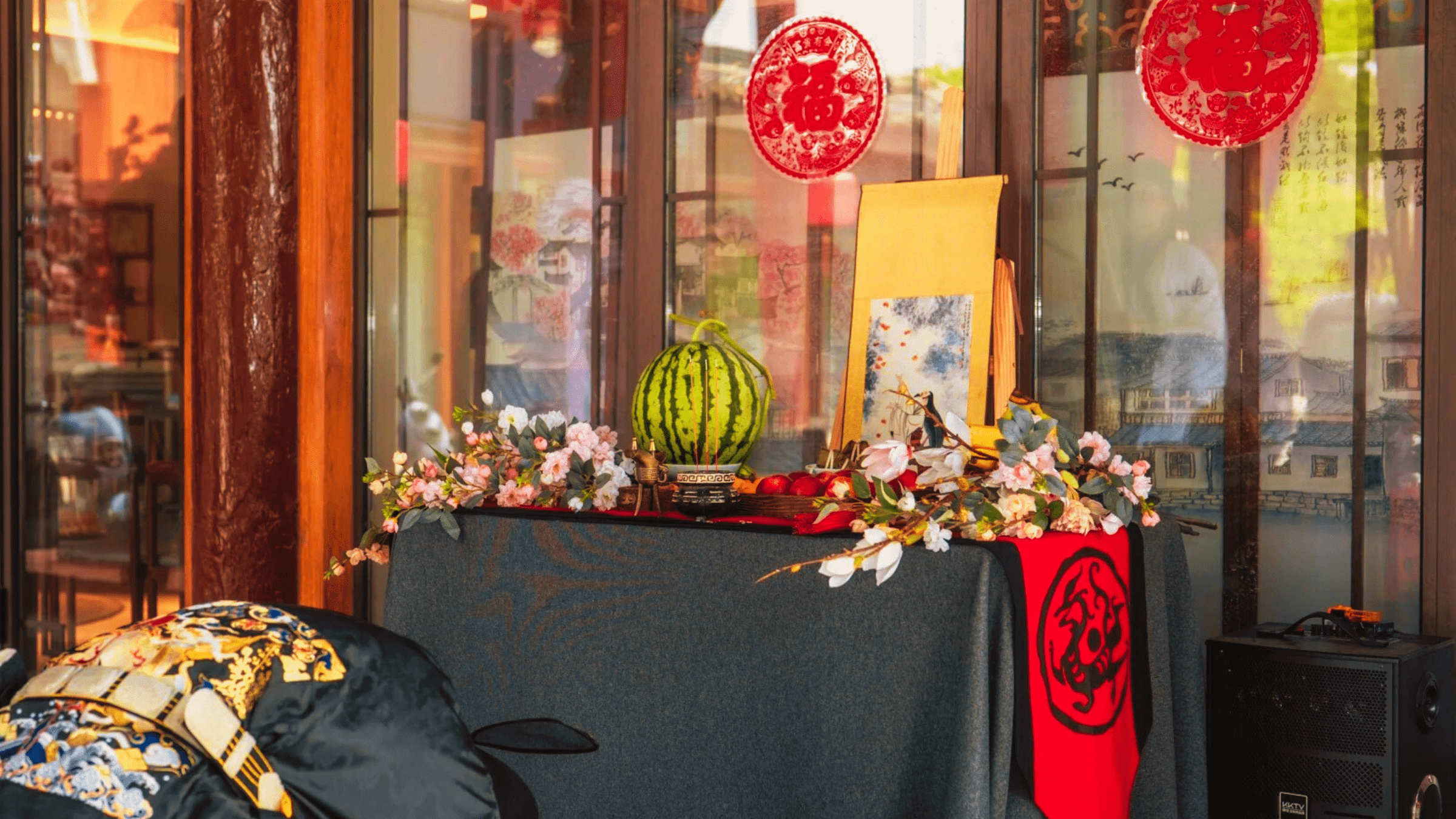 Modern ancestor worship altar with fruit offerings, traditional decorations, and symbolic elements in a Chinese cultural setting.