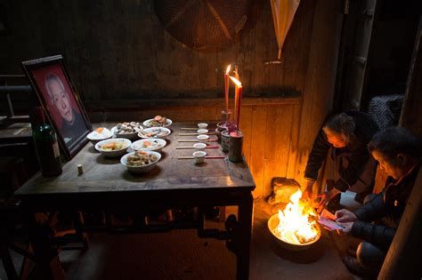 Traditional Chinese New Year ancestor worship ceremony with food offerings and burning incense