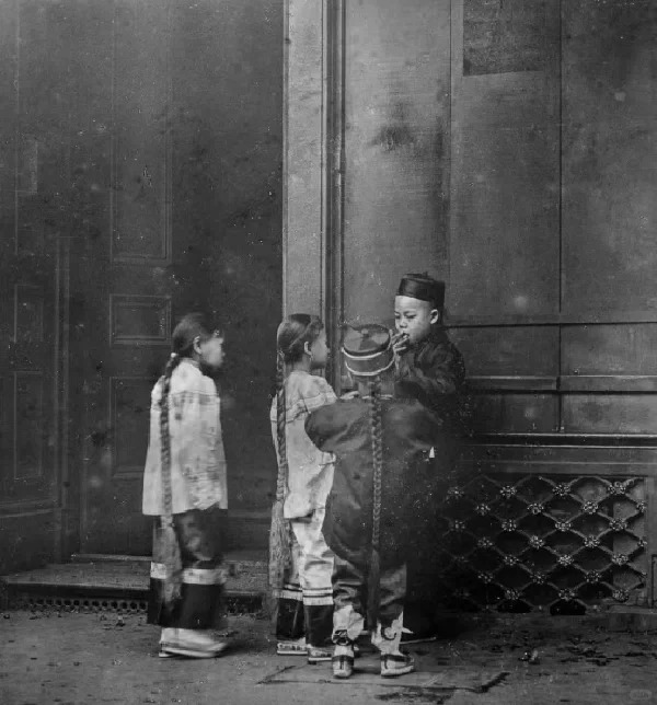 Historical photo of Chinese children in a 19th-century Chinatown, reflecting the impact of Chinese labor migration after the abolition of slavery.