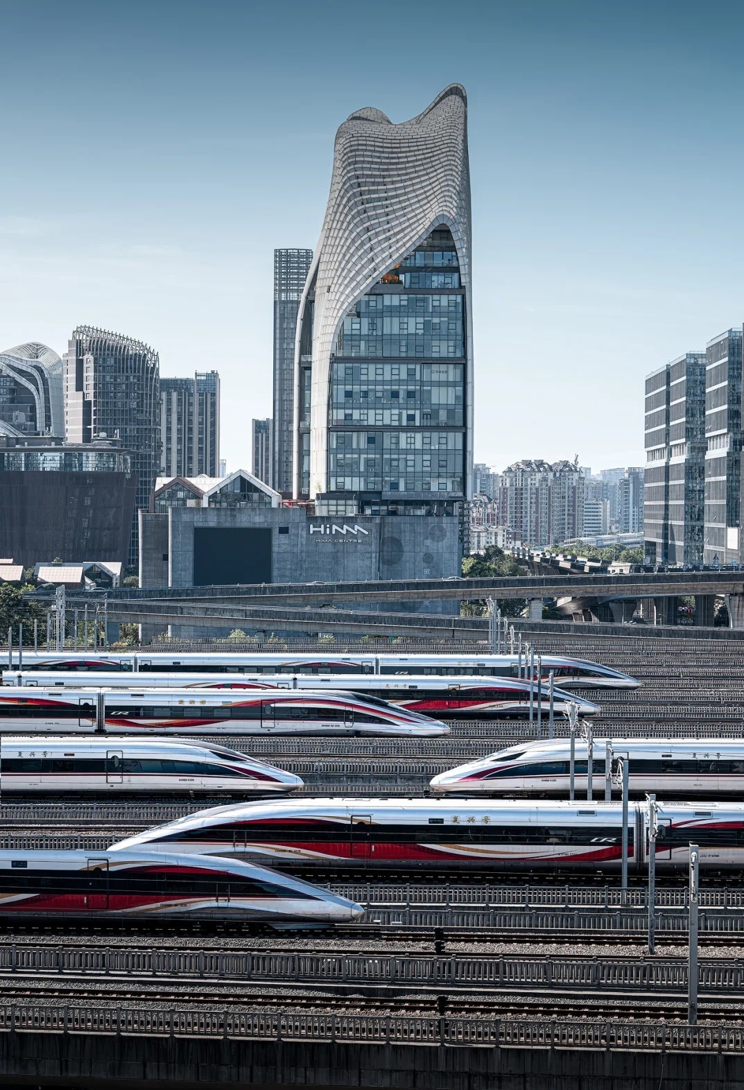 A bustling high-speed rail hub with sleek bullet trains in the Siyi Greater Bay Area, illustrating the region’s transportation advancements.