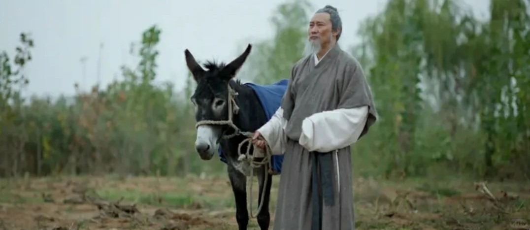 Elderly man in Hanfu holding a donkey’s reins in the countryside, representing agrarian wisdom in Tianxia tradition