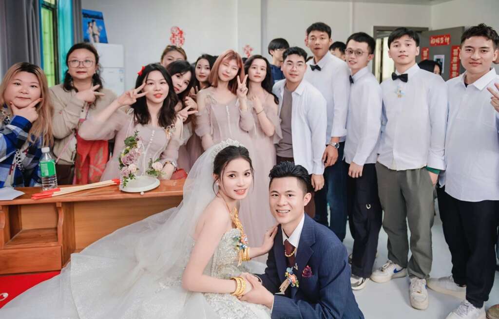 Newlywed couple with friends and family in a rural wedding, expressing personal and communal joy