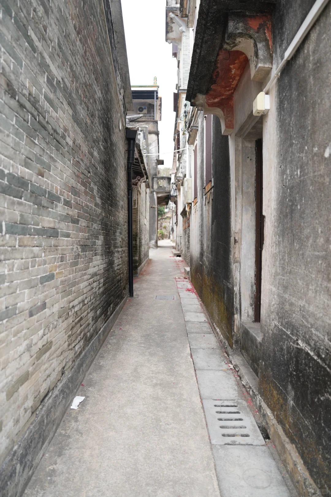 Narrow alleyway between traditional brick homes in rural China