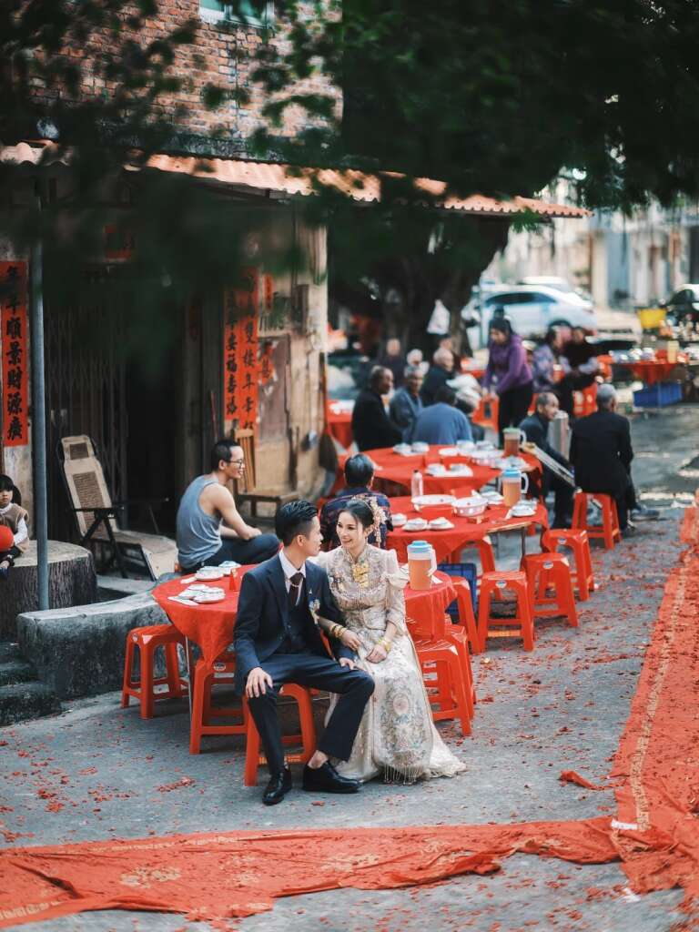 Village wedding banquet scene with couple and guests celebrating personal choice in marriage